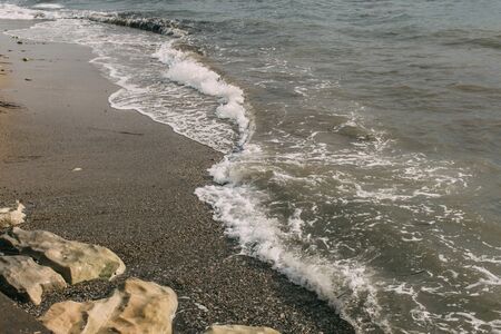 wet sand and rocks near mediterranean sea