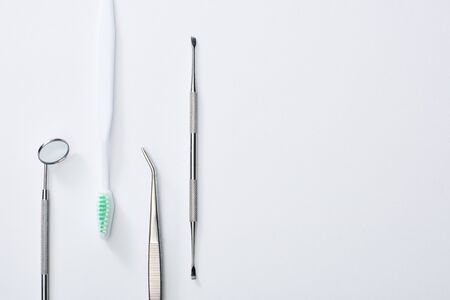 Top view of dental instruments and toothbrush on grey backgroundの写真素材