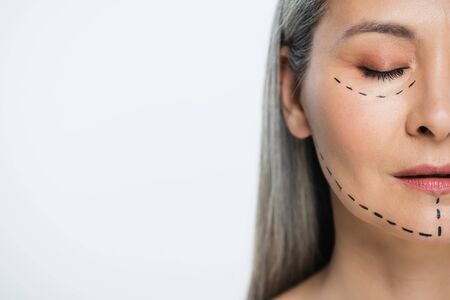 half view of face of asian woman with plastic surgery lines isolated on greyの写真素材