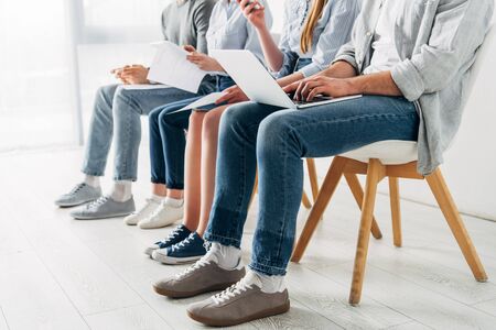 Cropped view of employees using digital devices in officeの写真素材