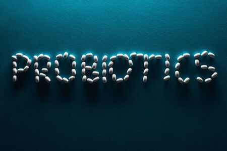 top view of probiotics lettering made of pills in dark on blue backgroundの写真素材