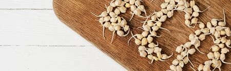 top view of word eco made of sprouts on cutting board on white wooden surface, panoramic cropの写真素材