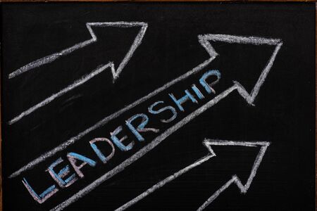 Drawn arrows with leadership lettering on black backgroundの写真素材