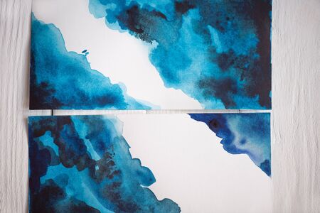 Top view of paper with Japanese painting with blue watercolor on wooden backgroundの写真素材