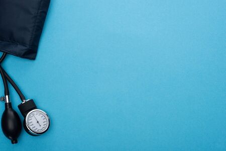 top view of sphygmomanometer on blue background