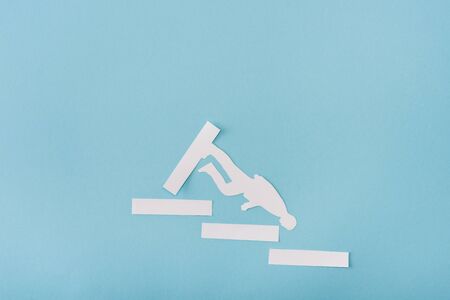 Top view of paper man and career ladder on blue backgroundの写真素材