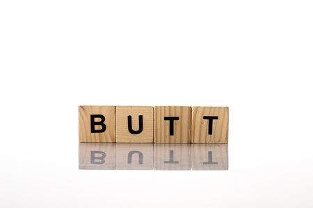 Wooden cubes with butt lettering on white backgroundの写真素材