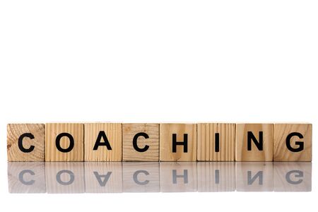 Wooden cubes with coaching lettering on whiteの写真素材