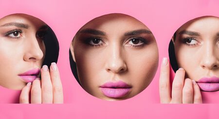Collage of woman with smoky eyes and pink lips looking across hole and touching paper, panoramic shotの写真素材