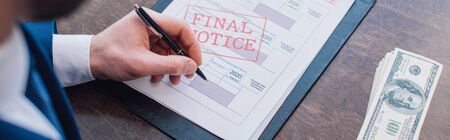Cropped view of collector writing in documents with final notice near dollar banknotes at table,...