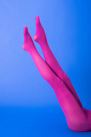 cropped view of woman in purple tights on blueの写真素材