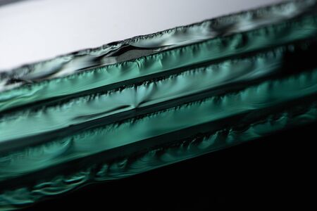 close up view of mirror pieces in stack on black backgroundの写真素材