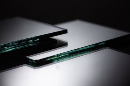 close up view of square mirror pieces in stack on blackの写真素材