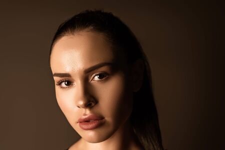 Portrait of beautiful woman looking at camera isolated on blackの写真素材