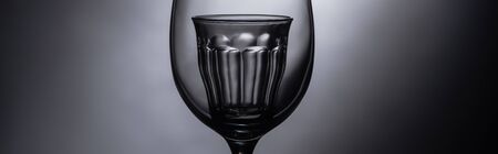 close up view of shot glass in wine glass in dark, panoramic shotの写真素材