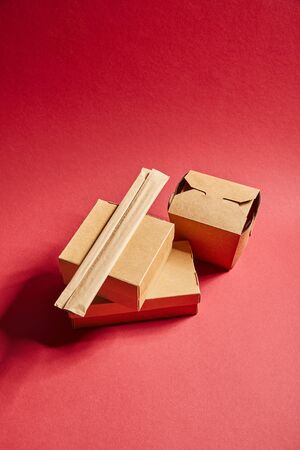 top view of takeaway carton boxes with traditional chinese food on red
