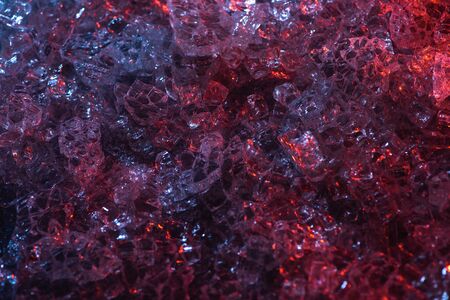 top view of dark abstract red and purple glass textured backgroundの写真素材