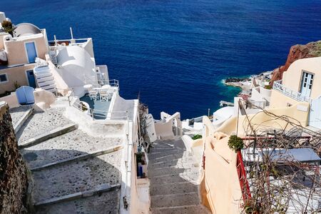 sunshine in houses and stairs near blue sea in greeceの写真素材