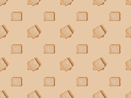 top view of fresh toast bread on beige background, seamless patternの写真素材