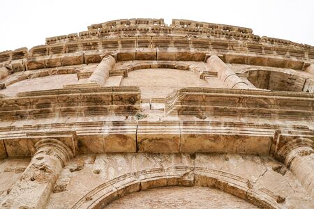 low angle view of ancient Colosseum against sky in romeの写真素材