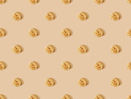 top view of fresh Tagliatelle on beige background, seamless pattern