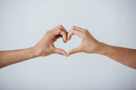 Cropped view of men gesturing love sign isolated on greyの写真素材