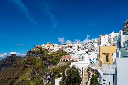  white houses on hill against blue sky in greek islandの写真素材
