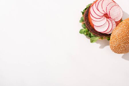 top view of delicious vegan burger with radish on white backgroundの写真素材