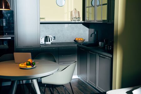 ripe and fresh fruits on plate in modern kitchen