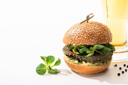 delicious green vegan burger with microgreens, oil, black pepper on white backgroundの写真素材