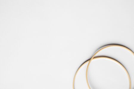 top view of beige knitting looms on white background with copy space