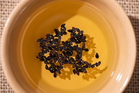 top view of oil with black sesame in bowlの写真素材