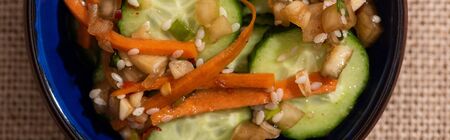 panoramic crop of pickled cucumbers with carrot and sesameの写真素材