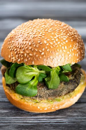 tasty vegan burger with microgreens served on wooden tableの写真素材