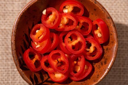 top view of red and spicy chili peppers in bowl