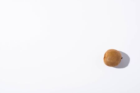 top view of whole kiwi fruit on white with copy spaceの写真素材