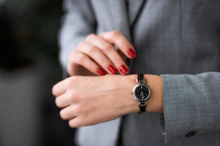 cropped view of businesswoman with bruise on hand touching watch, domestic violence conceptの写真素材