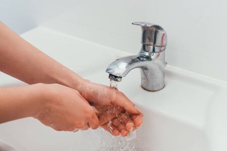 cropped view of girl washing hands on quarantine