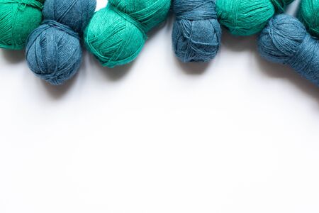 top view of blue and green wool yarn on white background with copy spaceの写真素材