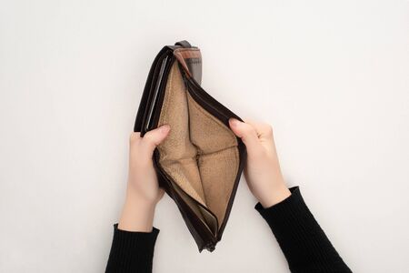 cropped view of woman holding empty wallet on white background