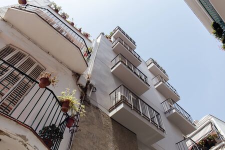 Low angle view of white facades of buildings with blue sky at background in Catalonia, Spainの写真素材