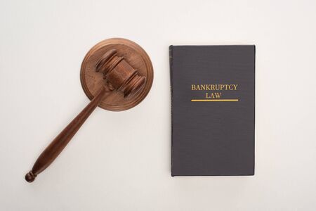 top view of bankruptcy law book and gavel on white backgroundの写真素材