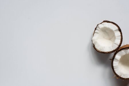 top view of fresh tasty coconut halves on white backgroundの写真素材