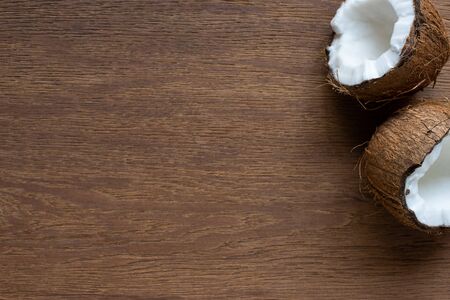 top view of fresh tasty cracked coconut on wooden table