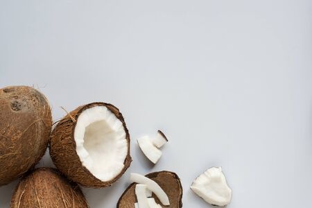top view of fresh tasty cracked coconuts with flakes and shell on white backgroundの写真素材
