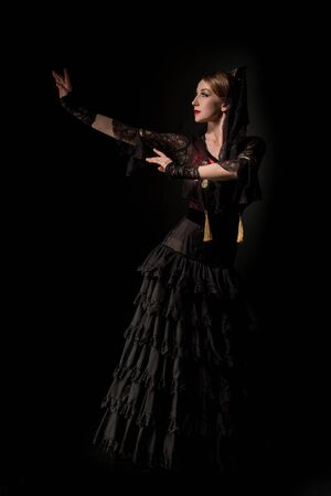 attractive girl dancing flamenco isolated on blackの写真素材
