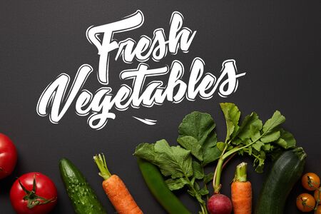 top view of raw nutritious tasty vegetables with green leaves on black background with fresh vegetables illustrationの写真素材
