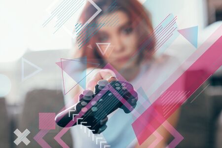 girl holding joystick at home on quarantine, selective focus with geometric symbols