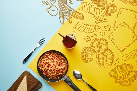 flat lay with delicious spaghetti with tomato sauce with parmesan on blue and yellow background with vegetables illustrationの写真素材