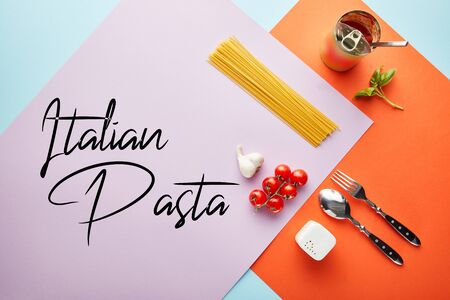 flat lay with delicious spaghetti with tomato sauce ingredients on red, blue and violet background with Italian pasta illustrationの写真素材